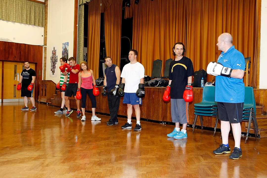 Coach Schwalm giving instructions to the class before the warm-up begins.