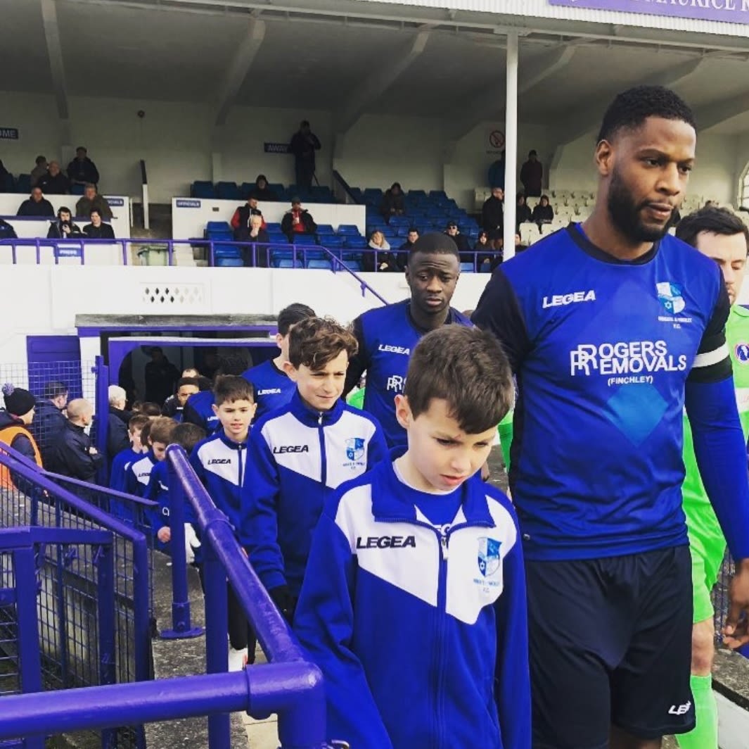 Ola Williams walking out the Wingate & Finchley team as captain.