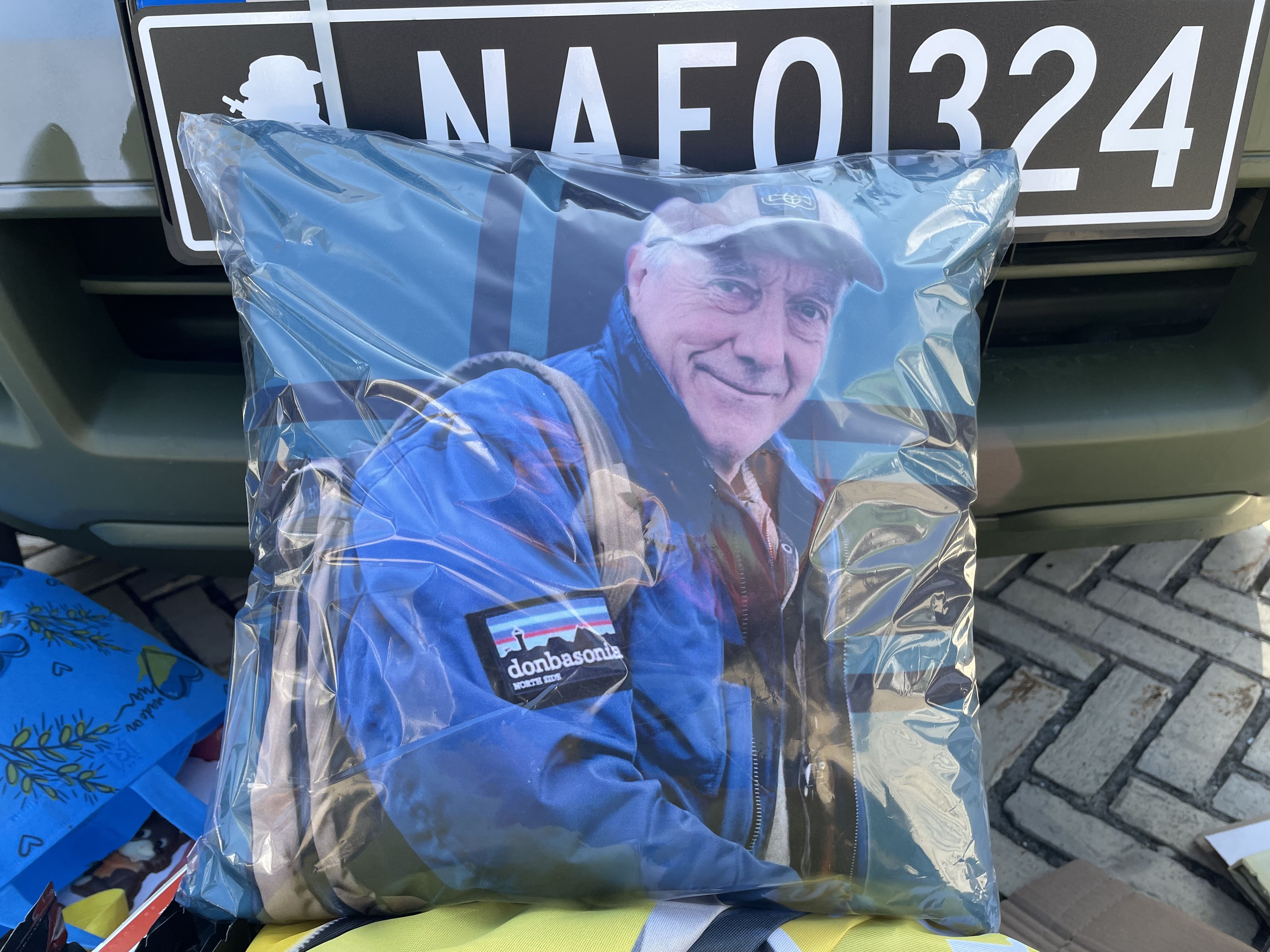 Cushion with a mans face on it.