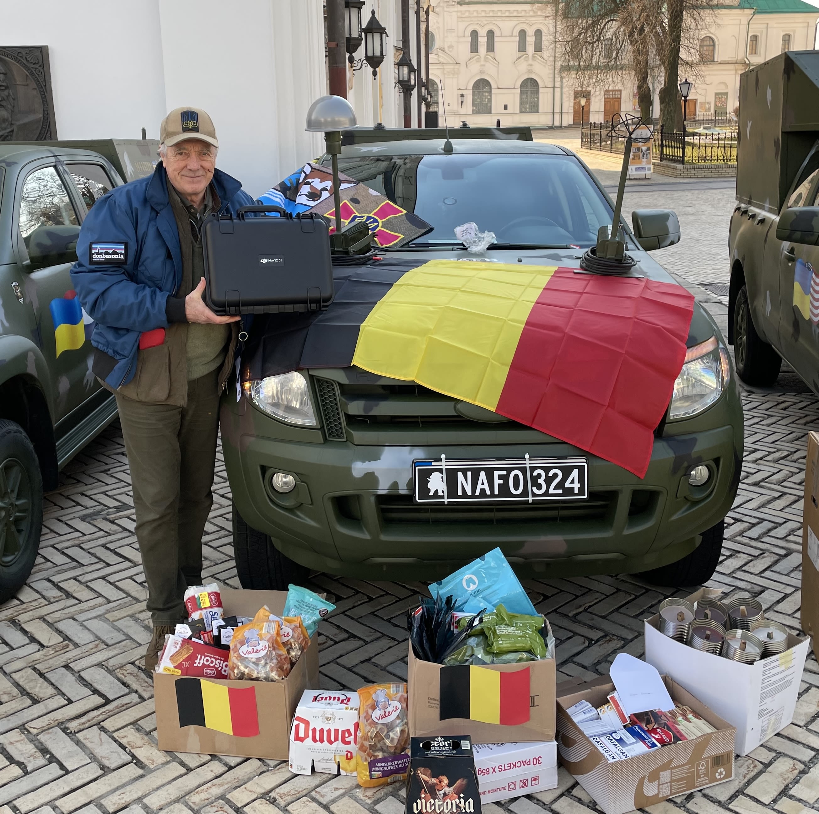 Man standing in front of a vehicle with gifts.