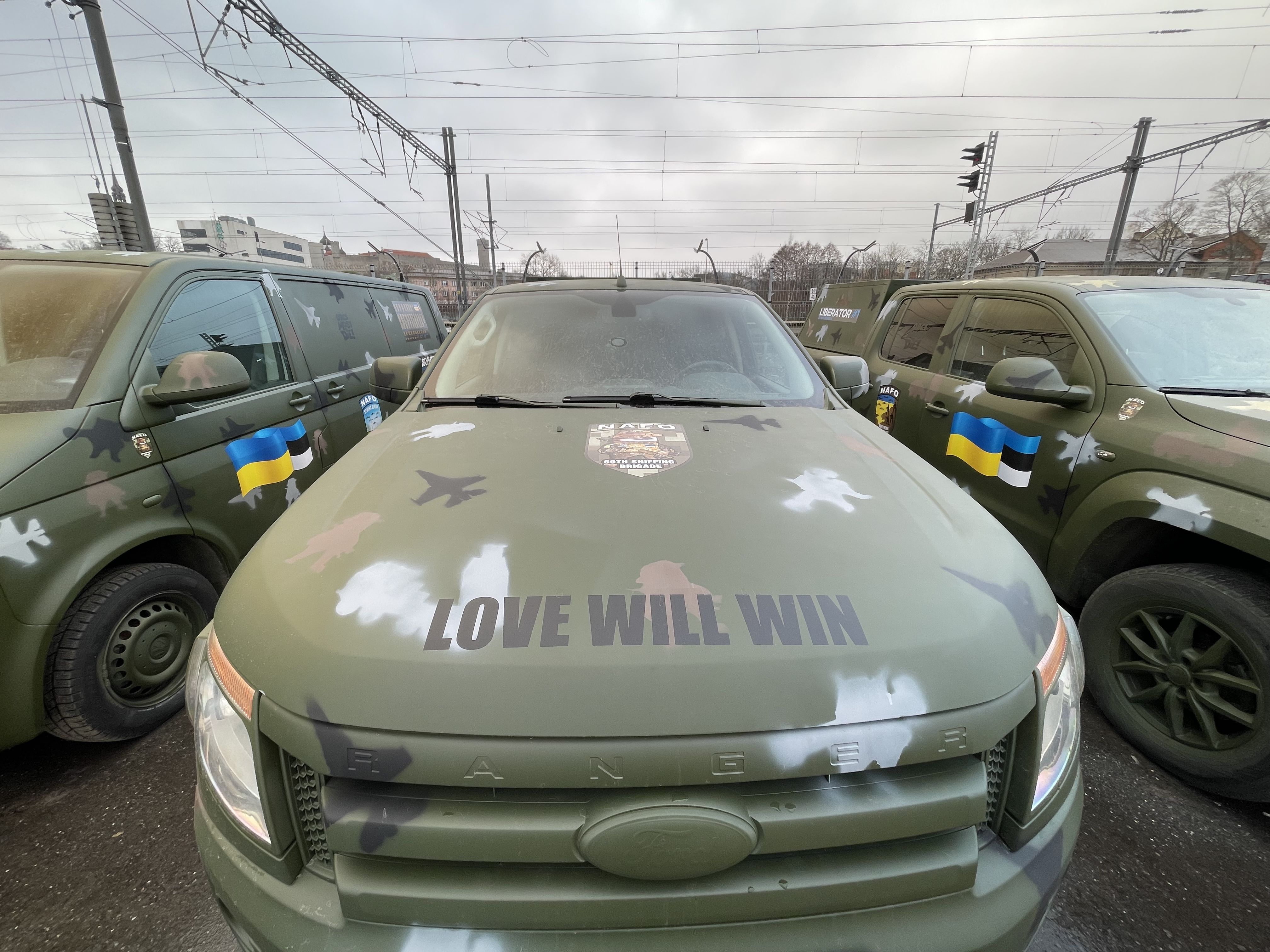 A military vehicle with "Love will win" on the bonnet.