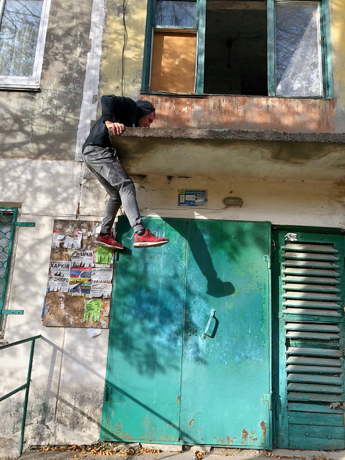 A volunteer climbs a building to try and rescue the animals trapped inside. Image credit: Aid Ukraine UK