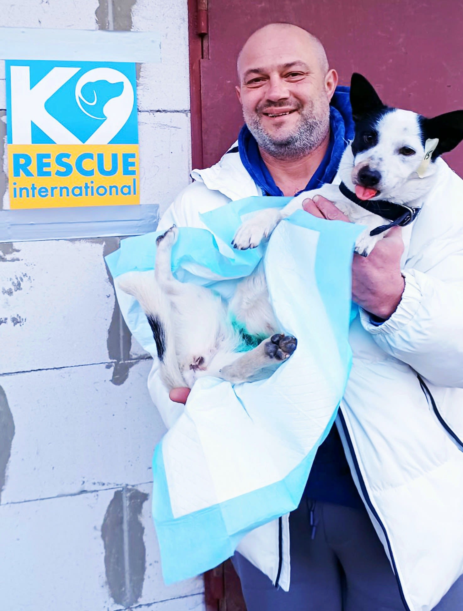 A pet owner holds his beloved pooch following sterilisation during one of K9 Rescue's recent campaigns in Ukraine. Image credit: K9 Rescue International